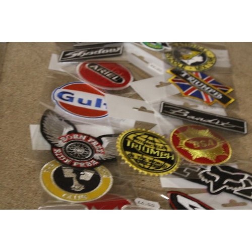 1306 - A QUANTITY OF MOTORING RELATED SEW ON BADGES - NEW IN PACKAGING