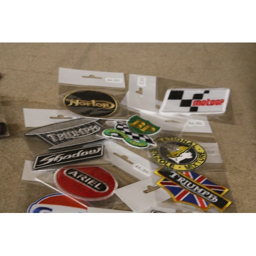 1306 - A QUANTITY OF MOTORING RELATED SEW ON BADGES - NEW IN PACKAGING