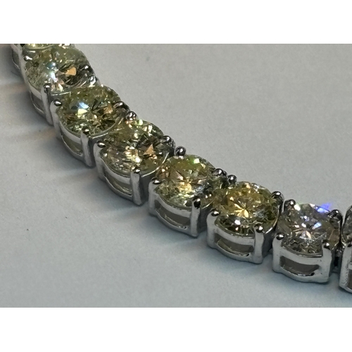 609 - A 14 CARAT WHITE GOLD TENNIS BRACELET WITH ROUND BRILLIANT CUT DIAMONDS TOTAL WEIGHT 9.02 CARATS WIT... 