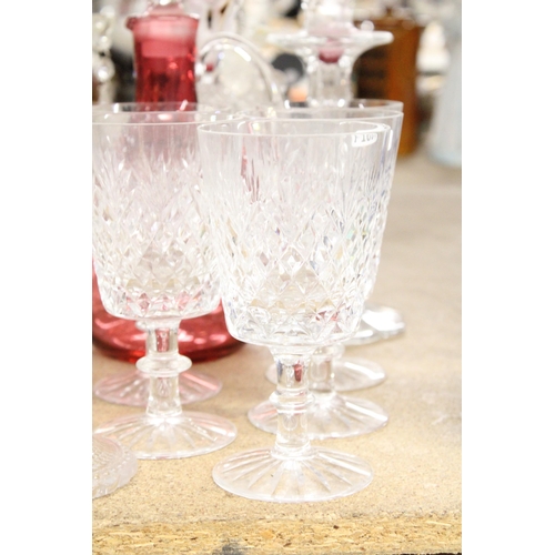 1170 - A QUANTITY OF GLASSWARE TO INCLUDE CANDLESTICKS, WINE GLASSES, A CRANBERRY GLASS DECANTER, ETC