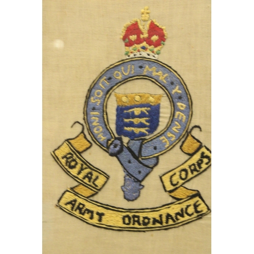 1175 - A FRAMED ROYAL ARMY ORDNANCE CORPS BADGE, STITCHED BY ANDREW LEWIS PETERS, WHILE IN HOSPITAL, 1942