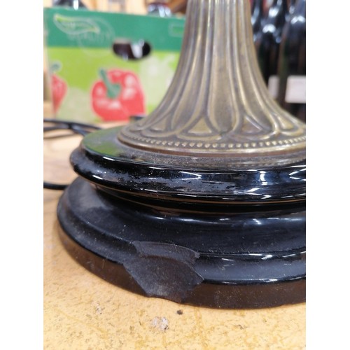 61 - A VICTORIAN OIL LAMP WITH MILKY GLASS SHADE AND GLASS RESERVOIR ON A BRASS COLUMN AND BLACK PLINTH