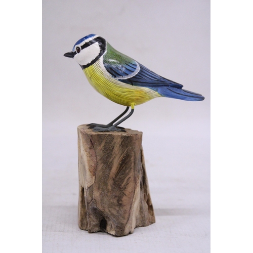 257 - A WOODEN BLUE TIT ON A WOODEN BASE, HEIGHT 15CM