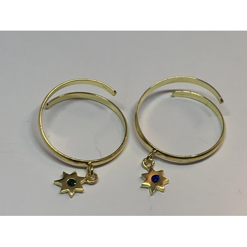 724 - FOUR MARKED SILVER GOLD PLATED RINGS WITH CHARMS