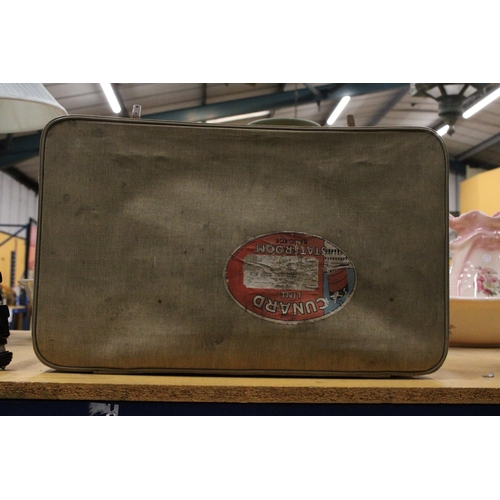 1026 - A VINTAGE SUITCASE BEARING A 'CUNARD LINE STATEROOM BAGGAGE' STICKER