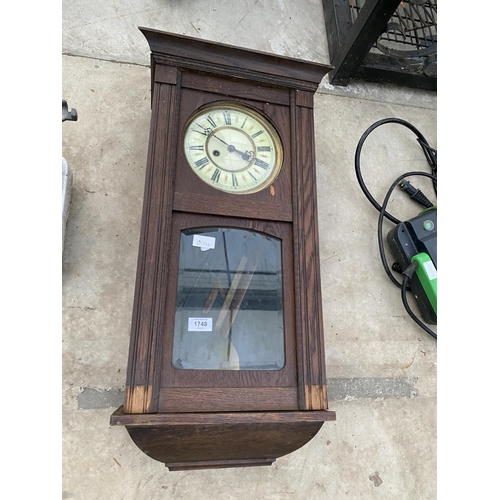 1748 - AN OAK CASED CHIMING WALL CLOCK