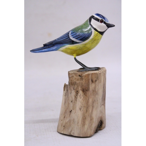 257 - A WOODEN BLUE TIT ON A WOODEN BASE, HEIGHT 15CM