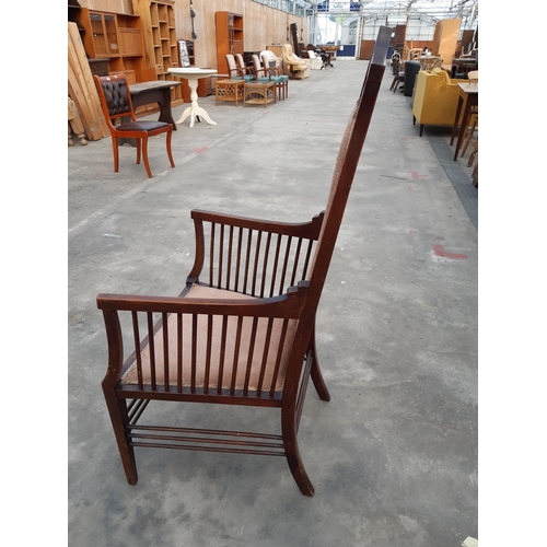 2875 - A HIGH BACK UPHOLSTERED ARMCHAIR IN THE RENNIE MACKINTOCH STYLE WITH TALL BACK AND MULTIPLE SPINDLES