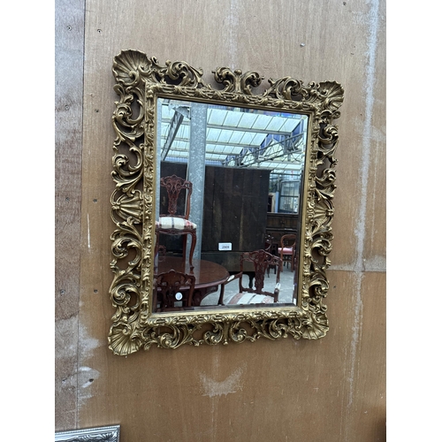 2909 - A 19TH CENTURY STYLE GILT EFFECT BEVEL EDGE WALL MIRROR WITH SCROLLED FOLIATE DECORATION, 33