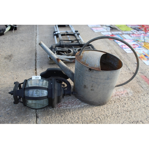 369 - A GALVANISED WATERING CAN AND COURTYARD LIGHT  NO VAT