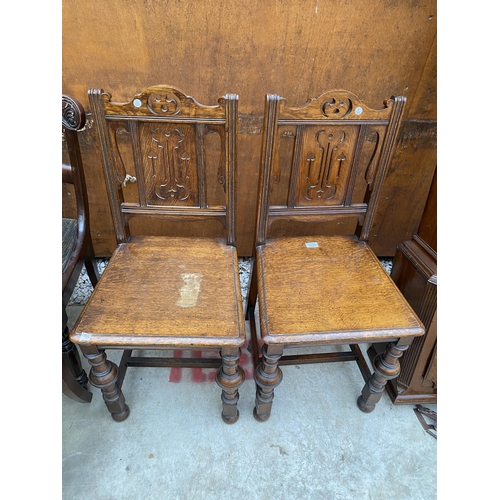 2525 - A PAIR OF 19TH CENTURY OAK HALL CHAIRS WITH TURNED FRONT LEGS AND PARTIAL FRETWORK BACK PANELS