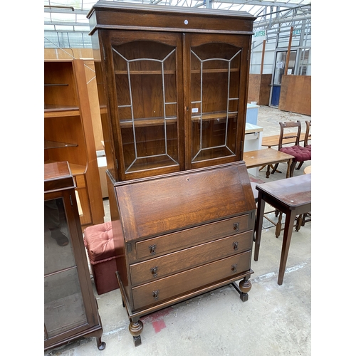 2534 - AN EARLY 20TH CENTURY OAK BUREAU BOOKCASE WITH GLAZED AND LEADED UPPER PORTION, 34.5