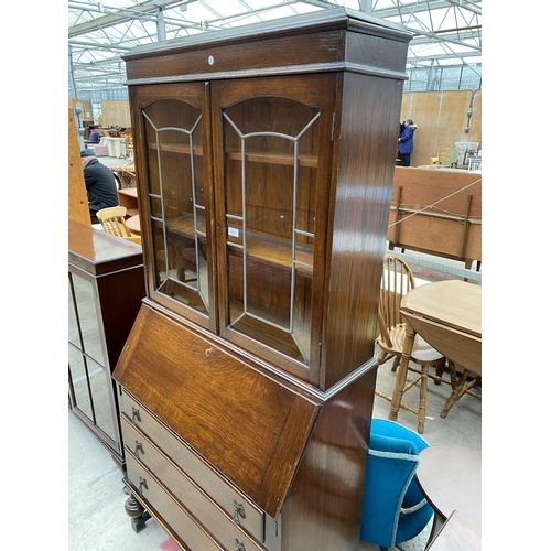 2534 - AN EARLY 20TH CENTURY OAK BUREAU BOOKCASE WITH GLAZED AND LEADED UPPER PORTION, 34.5