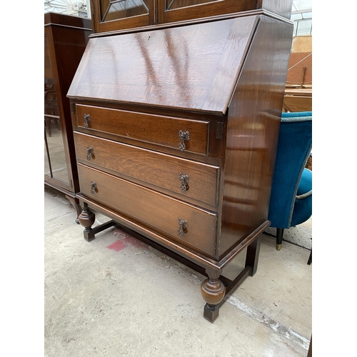 2534 - AN EARLY 20TH CENTURY OAK BUREAU BOOKCASE WITH GLAZED AND LEADED UPPER PORTION, 34.5