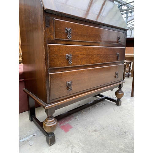 2534 - AN EARLY 20TH CENTURY OAK BUREAU BOOKCASE WITH GLAZED AND LEADED UPPER PORTION, 34.5