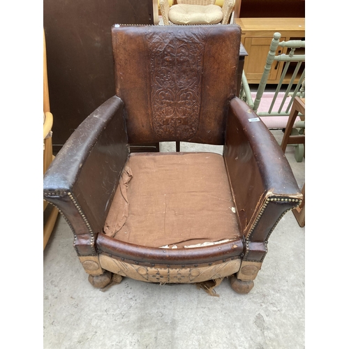 2538 - AN EARLY 20TH CENTURY LEATHER STUDDED FIRESIDE CHAIR