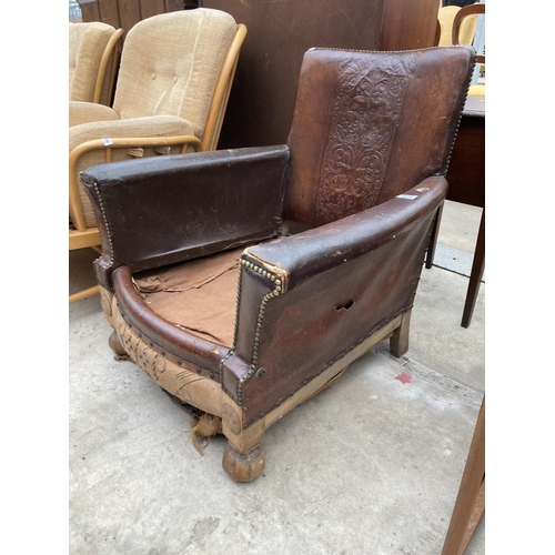 2538 - AN EARLY 20TH CENTURY LEATHER STUDDED FIRESIDE CHAIR