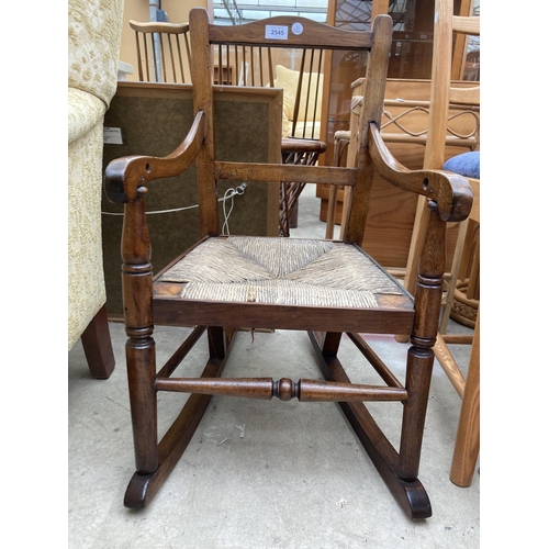 2545 - A 19TH CENTURY BEECH CHILDS ROCKING CHAIR WITH RUSH SEAT