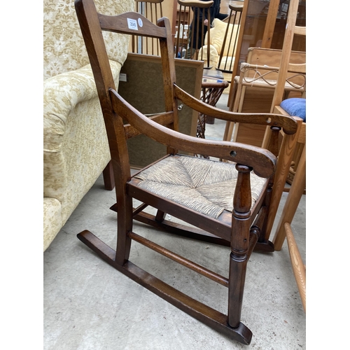 2545 - A 19TH CENTURY BEECH CHILDS ROCKING CHAIR WITH RUSH SEAT