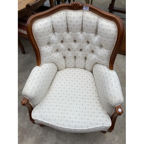 2558 - A CONTINENTAL STYLE BUTTON BACK FIRESIDE CHAIR WITH FOLIATE CARVING