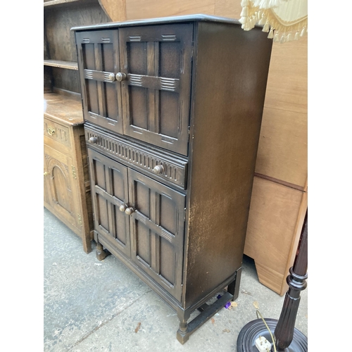 2572 - AN OAK COCKTAIL CABINET WITH PULL OUT SLIDE, PANELLED DOORS AND SINGLE DRAWER, 32