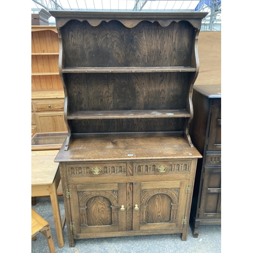 2573 - AN OAK JACOBEAN STYLE DRESSER WITH PLATE RACK, 42