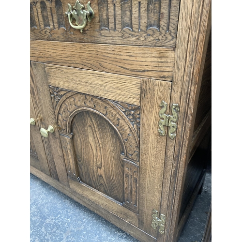 2573 - AN OAK JACOBEAN STYLE DRESSER WITH PLATE RACK, 42