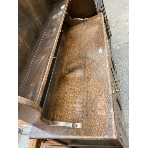 2573 - AN OAK JACOBEAN STYLE DRESSER WITH PLATE RACK, 42