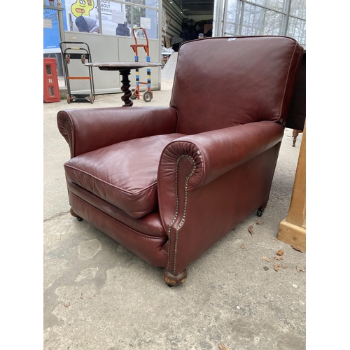 2576 - A LEATHER EASY CHAIR WITH BUN FRONT FEET