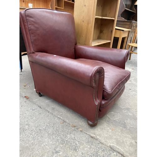 2576 - A LEATHER EASY CHAIR WITH BUN FRONT FEET