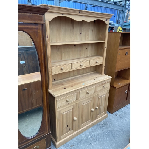 2581 - A PINE DRESSER WITH CUPBOARDS AND DRAWERS TO BASE HAVING PLATE RACK ENCLOSING THREE DRAWERS, 50