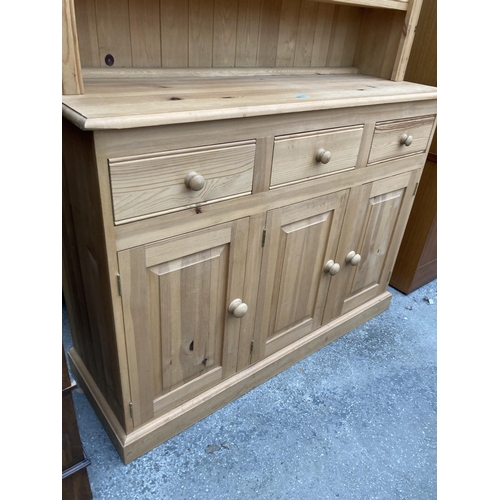 2581 - A PINE DRESSER WITH CUPBOARDS AND DRAWERS TO BASE HAVING PLATE RACK ENCLOSING THREE DRAWERS, 50