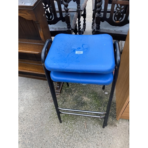 2584 - A PAIR OF PLASTIC STACKING STOOLS ON TUBULAR METAL FRAMES