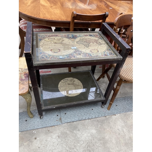 2591 - A TWO TIER TROLLEY ENCLOSING BRASS FRAMED WORLD MAPS