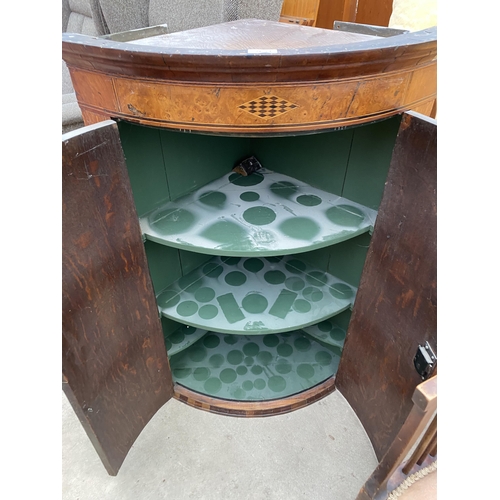 2634 - A GEORGE III OAK AND CROSSBANDED BOW FRONTED CORNER CUPBOARD WITH H BRASS HINGES, 26.5