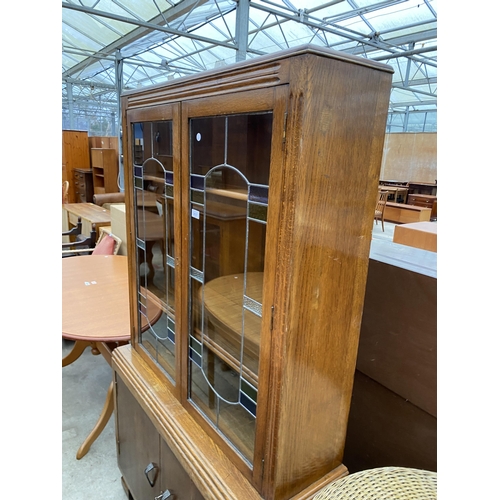 2637 - A MID 20TH CENTURY BOOKCASE WITH COLOURED GLASS AND LEADED UPPER PORTION AND CUPBOARDS TO BASE, 37