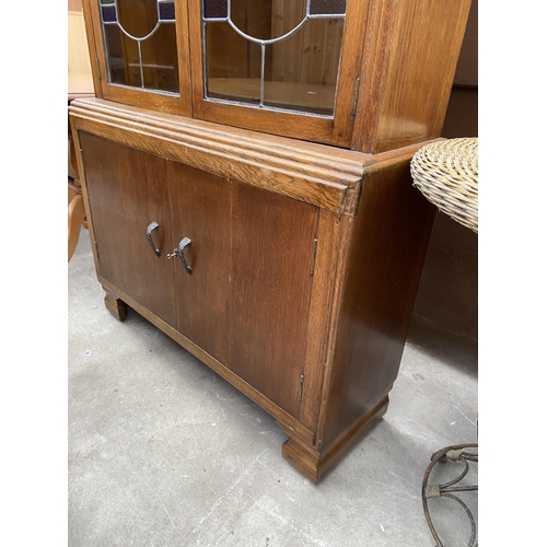 2637 - A MID 20TH CENTURY BOOKCASE WITH COLOURED GLASS AND LEADED UPPER PORTION AND CUPBOARDS TO BASE, 37