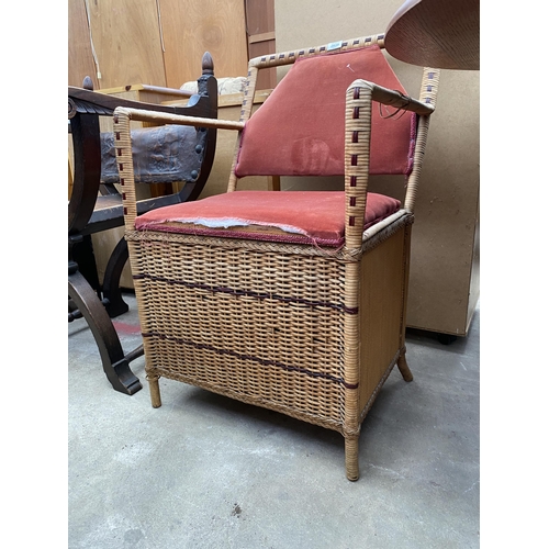 2639 - A WICKER ELBOW CHAIR WITH LIFT UP SEAT