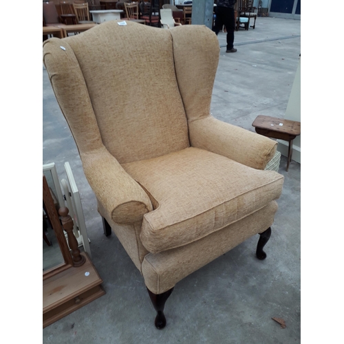 2699 - A MULTIYORK WINGED FIRESIDE CHAIR WITH FRONT CABRIOLE LEGS