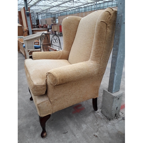 2699 - A MULTIYORK WINGED FIRESIDE CHAIR WITH FRONT CABRIOLE LEGS