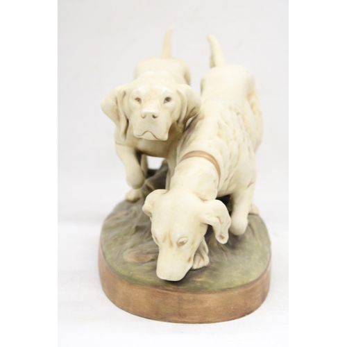 1 - A ROYAL DUX EARLY 20TH CENTURY BISQUE PORCELAIN MODEL OF A POINTER AND RETRIEVER ON A NATURALISTICAL... 