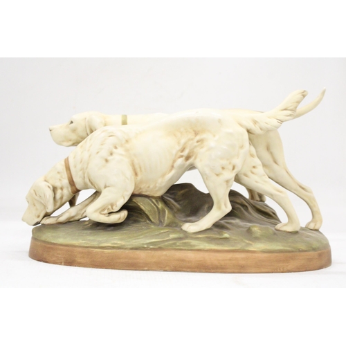 1 - A ROYAL DUX EARLY 20TH CENTURY BISQUE PORCELAIN MODEL OF A POINTER AND RETRIEVER ON A NATURALISTICAL... 