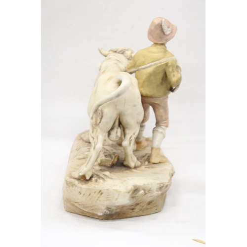 2 - AN EARLY 20TH CENTURY BISQUE PORCELAIN ROYAL DUX FIGURE OF A YOUNG MAN BESIDE A HARNESSED OX - PINK ... 