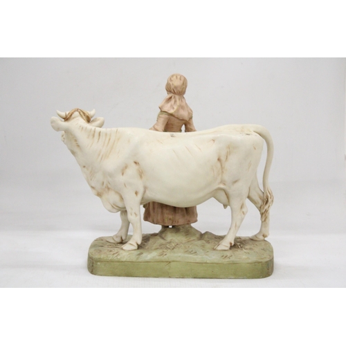 45 - A ROYAL DUX BISQUE PORCELAIN EARLY 20TH CENTURY FIGURE GROUP MODELLED AS A MILKMAID WITH COW