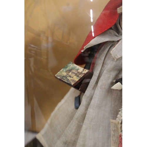 53 - A VICTORIAN HAND BLOWN GLASS DOME WITH A FIGURE OF A WELSH STREET SELLER ON A WOODEN BASE