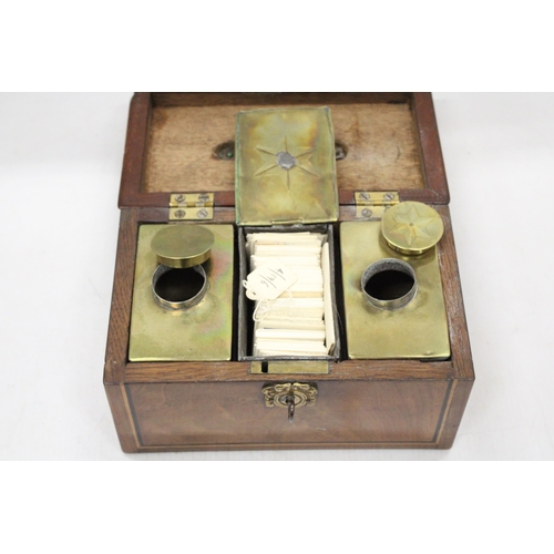 54 - AN INLAID TEA CHEST WITH KEY AND BRASS INTERIOR AND TEA CARDS