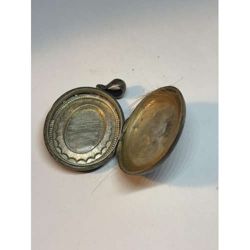 757 - A POSSIBLY SILVER MOURNING LOCKET WITH YELLOW AND ROSE GOLD COLOURED DECORATION