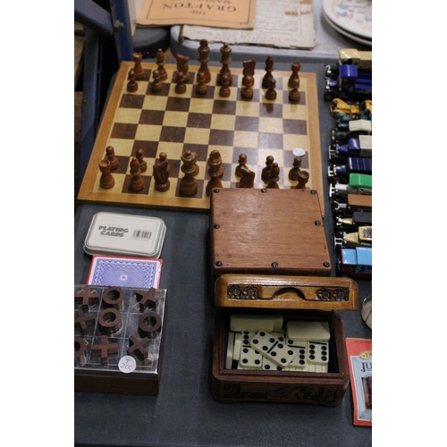 974 - A QUANTITY OF GAMES TO INCLUDE A CHESS BOARD WITH PIECES, NOUGHTS AND CROSSES, DOMINOES AND CARDS, S... 