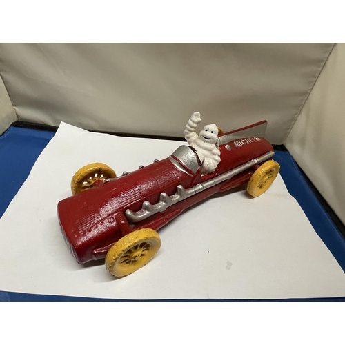 14 - A RED CAST MICHELIN MAN RACING CAR