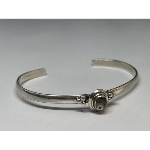 63 - A MARKED SILVER BANGLE WITH MOTHER OF PEARL STONE GROSS WEIGHT 14.4 GRAMS